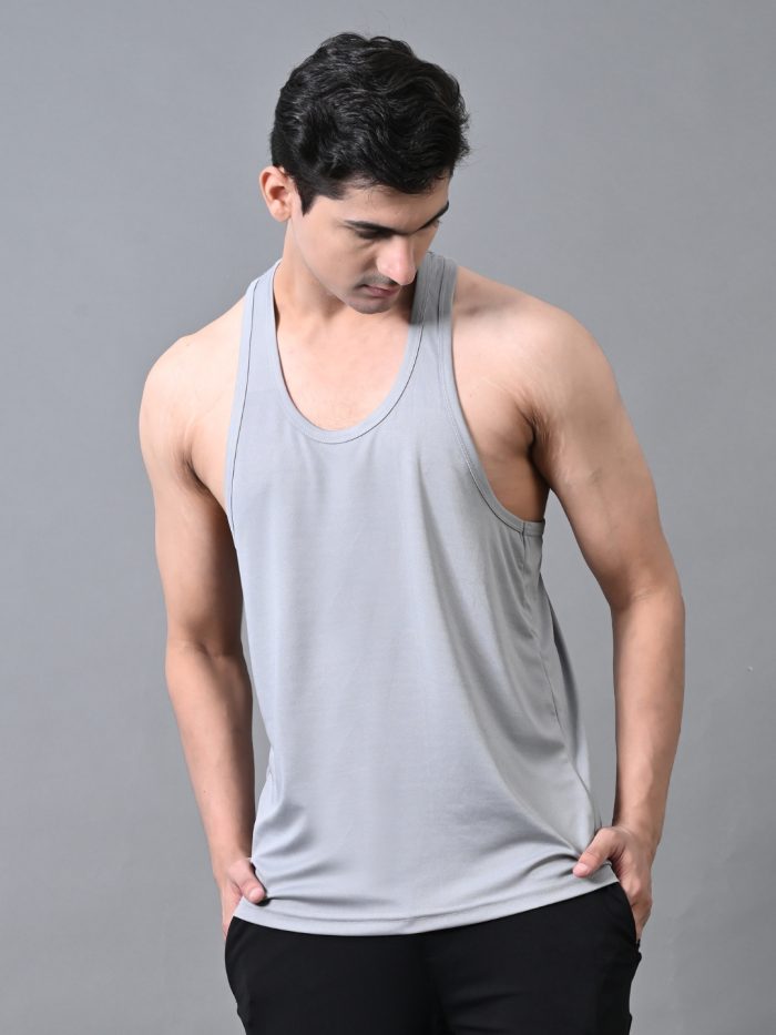 A man wearing a gray gym vest, designed for fitness workouts, running, and training.