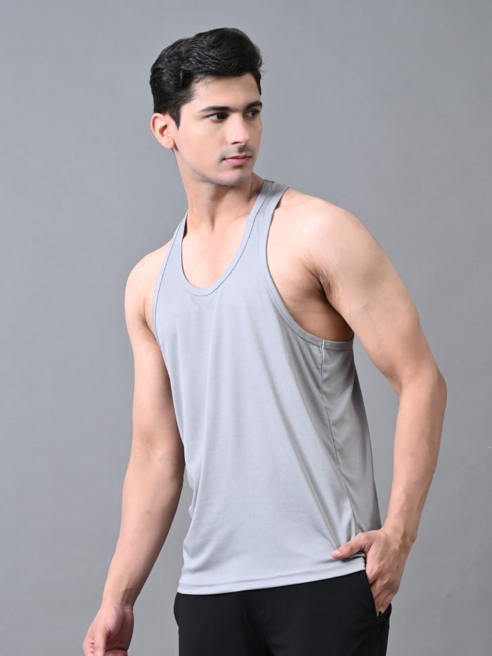 A man wearing a gray gym vest, designed for fitness workouts, running, and training.