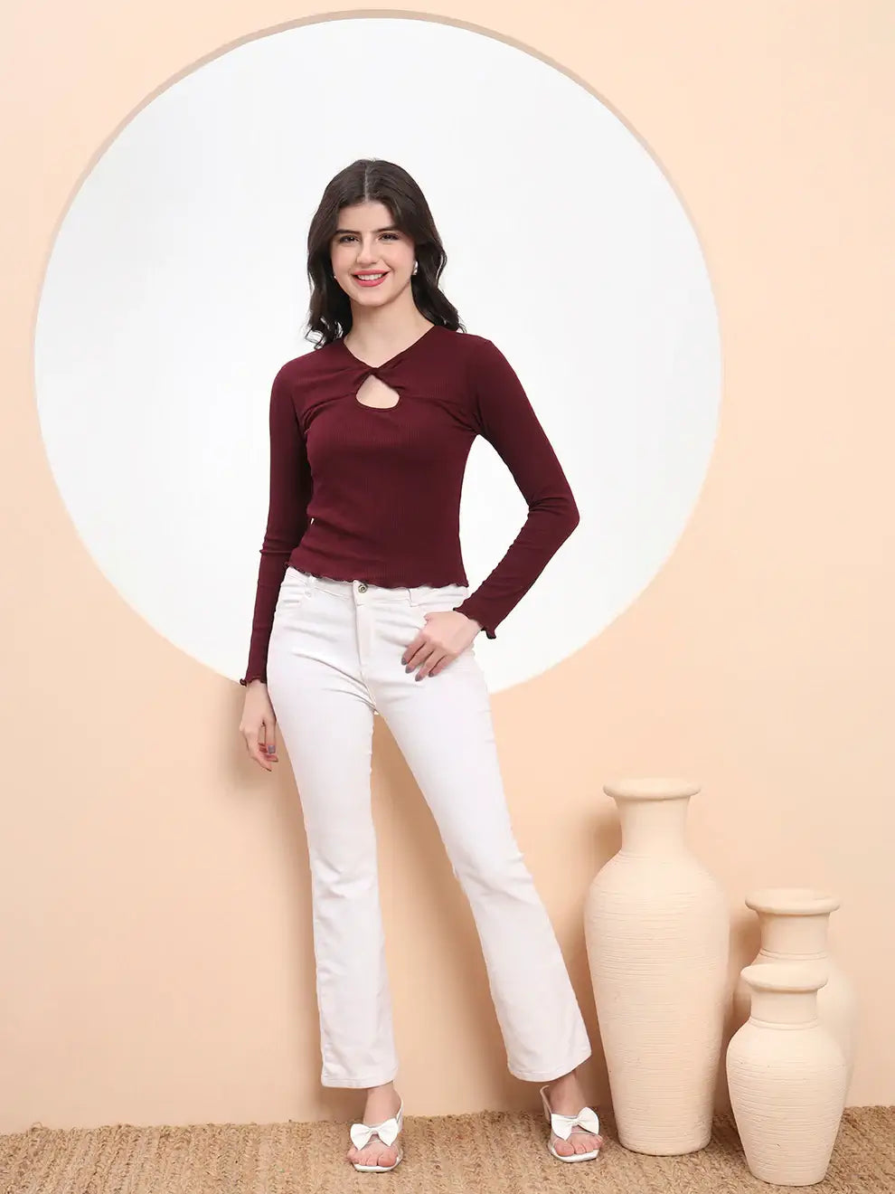Woman wearing a burgundy long-sleeve Twist & Turn Wine Fitted Top