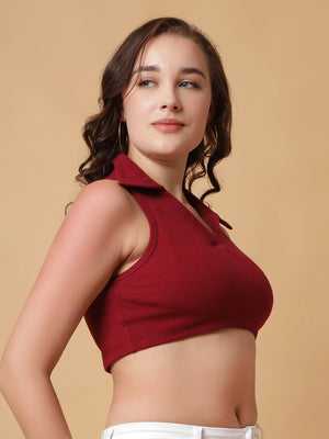 Woman wearing a red sleeveless top against a beige background