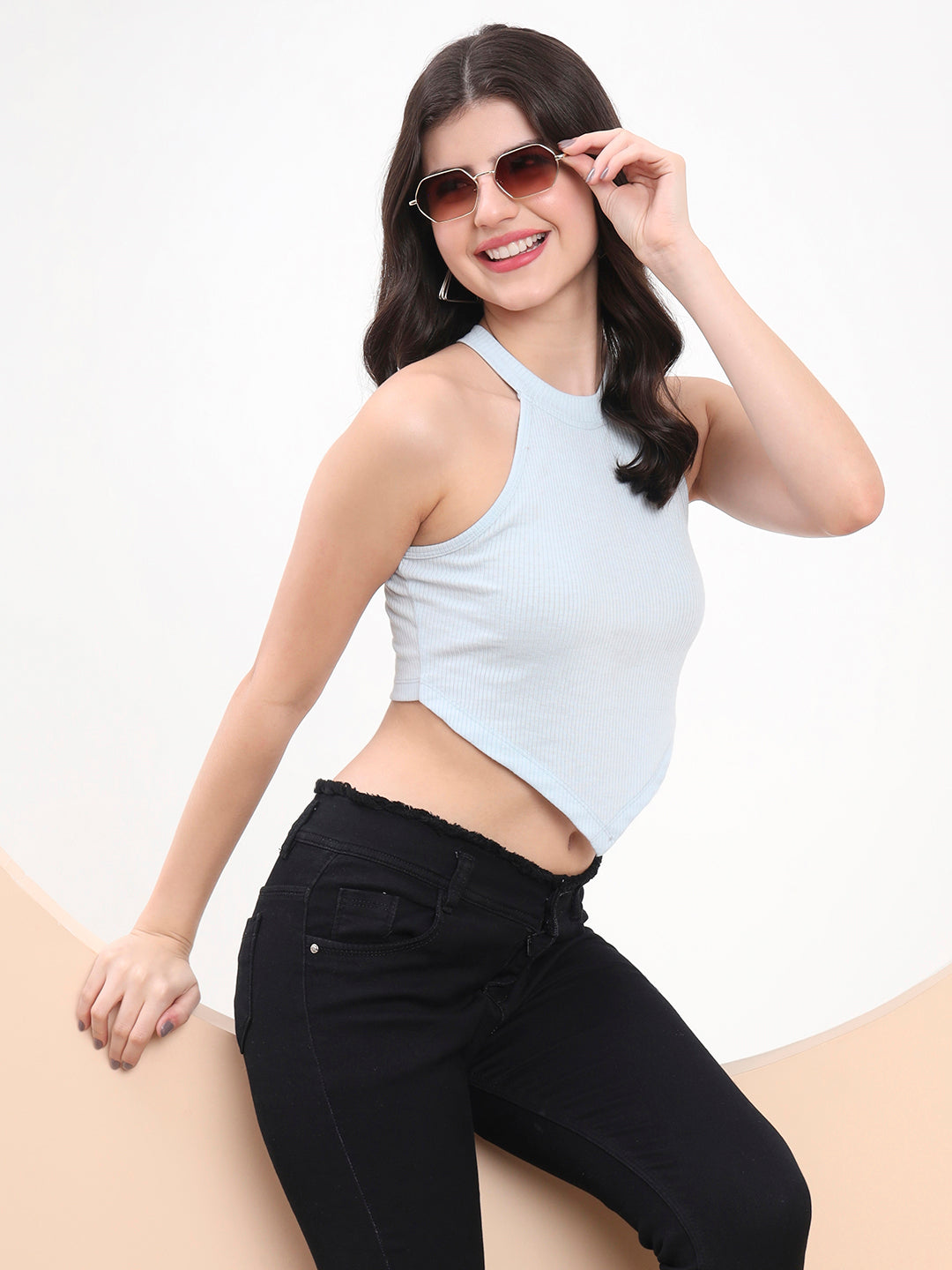 Woman wearing a light blue Skyline Asymmetry Halter Crop Top